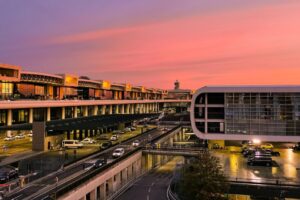 Luxury chauffeur welcoming international passengers at Milan Malpensa Airport (MXP) for private transfers to Milan, Lake Como, Switzerland and Northern Italy.