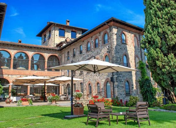 Castello di Casiglio in Erba surrounded by historic gardens and medieval architecture.