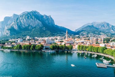 Lecco waterfront with the Resegone mountain served by MC Eurodriver's luxury chauffeur and private transfer services.