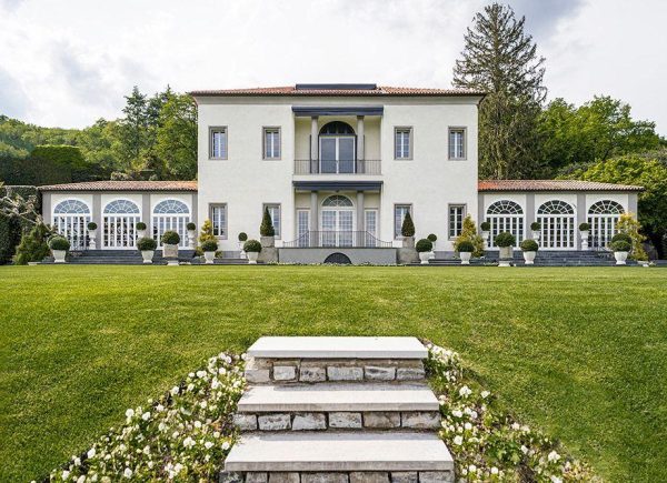 Villa Bonomi overlooking Lake Como with elegant gardens and historic architecture.